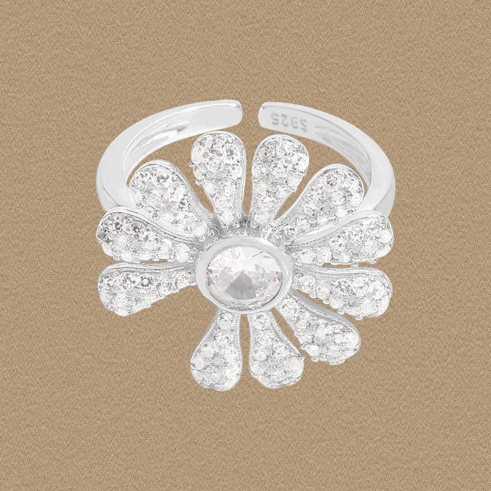 Polished sterling silver flower ring with a central crystal surrounded by pavé petals.