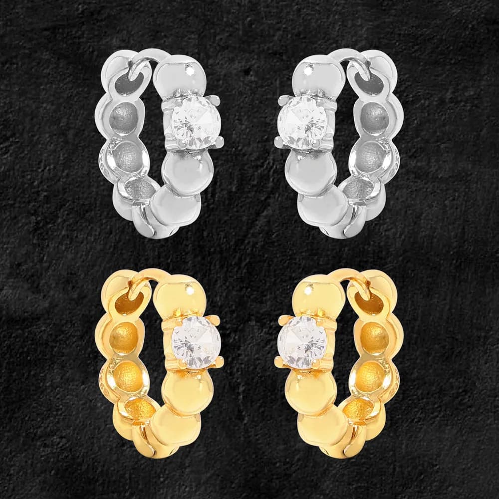Polished circle-link hoop earrings in silver and gold-tone with a central crystal on the front