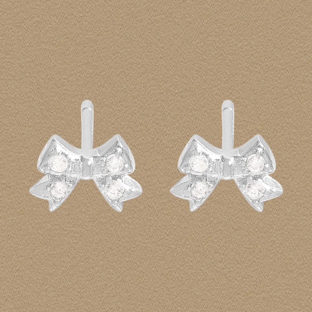 Pair of polished sterling silver bow-shaped stud earrings with small stones.