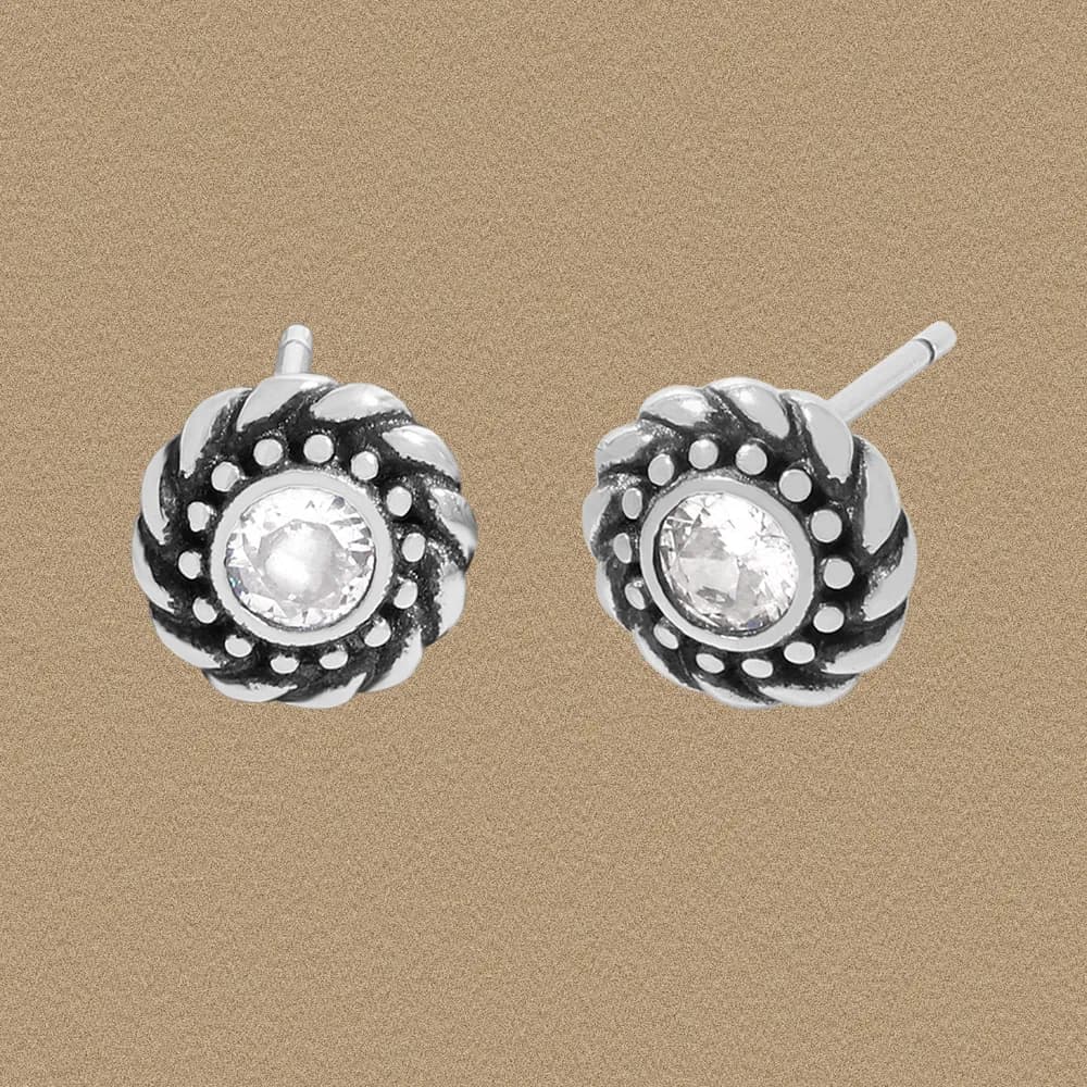 Sterling silver floral stud earrings with a central clear gemstone