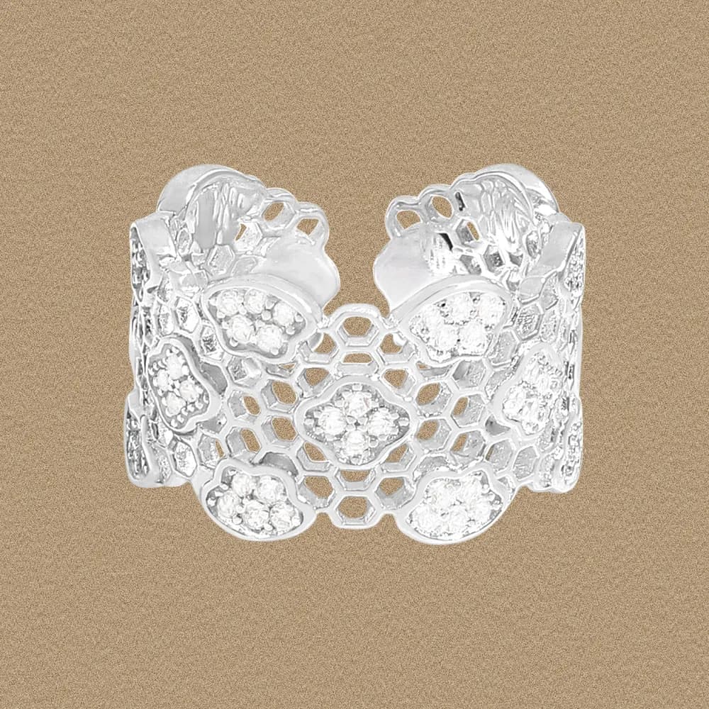 Polished sterling silver ring with an open honeycomb lattice and floral pavé accents.