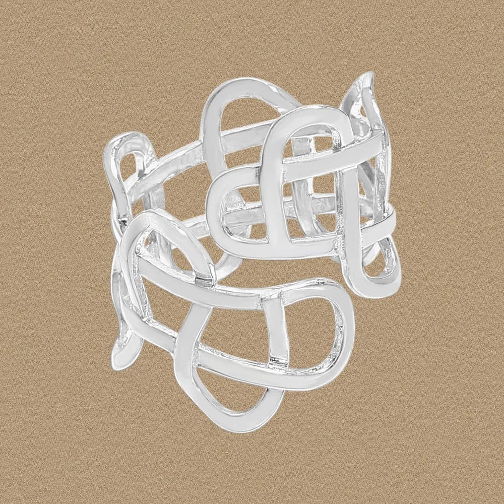Polished sterling silver interwoven loop ring photographed against a warm gradient background.