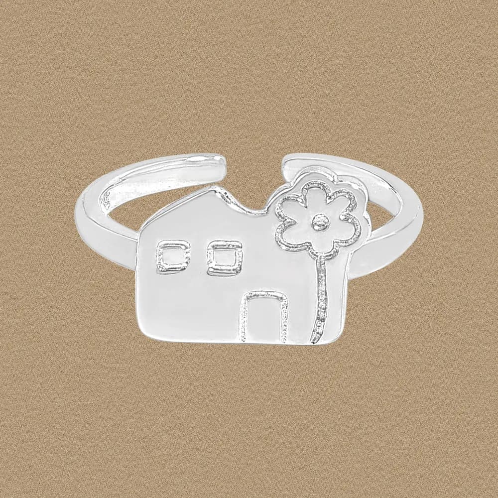 Polished sterling silver ring with a flat house shape and a flower embellishment on the right side.