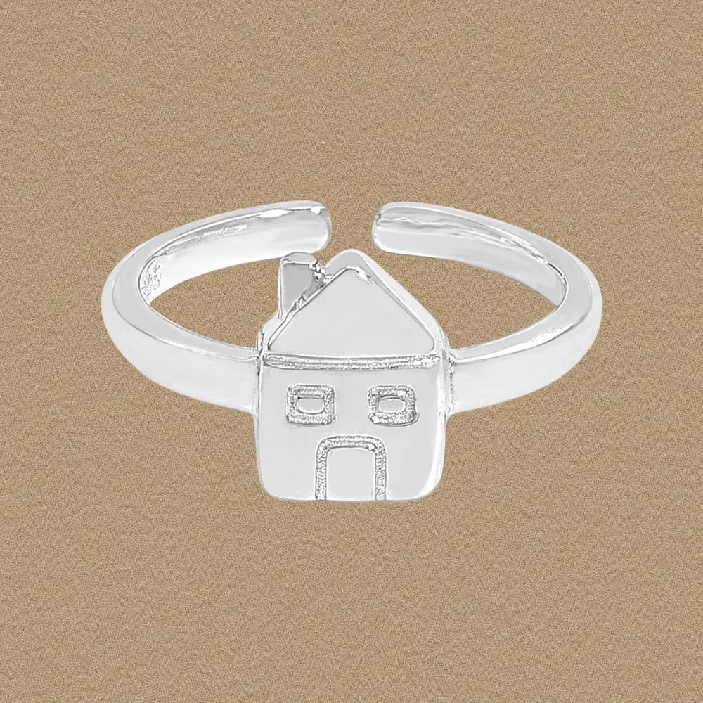 Polished sterling silver ring with a small house silhouette, triangular roof, two windows, and doorway on the front.