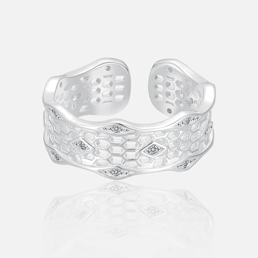 Polished sterling silver honeycomb cuff ring with a wide, open design and scattered stones.