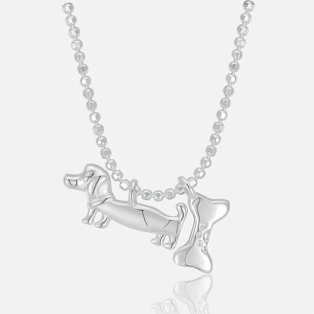 Polished sterling silver dachshund and bone pendant on a rounded-link chain necklace.