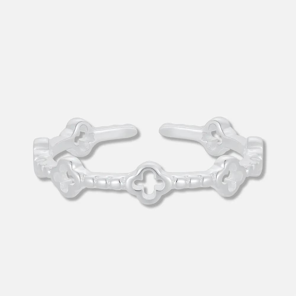 Polished sterling silver ring with clover-shaped openwork motifs along a slim band.