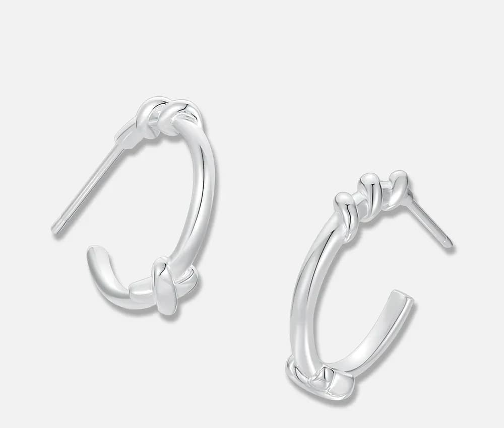 Polished sterling silver knot hoop earrings with open hoops and post backs.