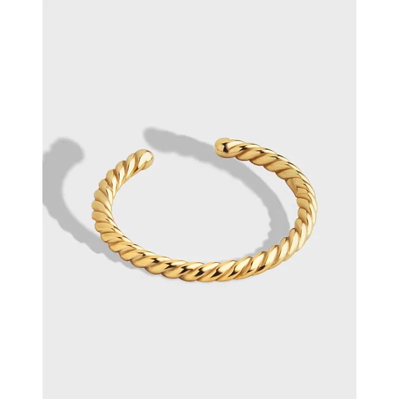 Open-ended twisted rope ring in polished metal sits on a light grey background.
