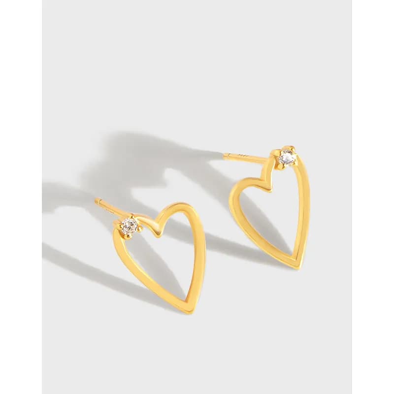 Polished sterling silver open heart hoop earrings with a small clear stone at the top