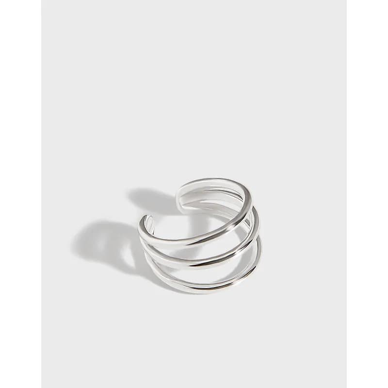 A polished triple-band hoop earring sits elegantly on a white background.