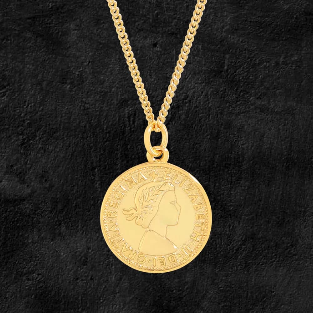 Gold-toned coin pendant on a sterling silver chain with a raised profile and engraved border