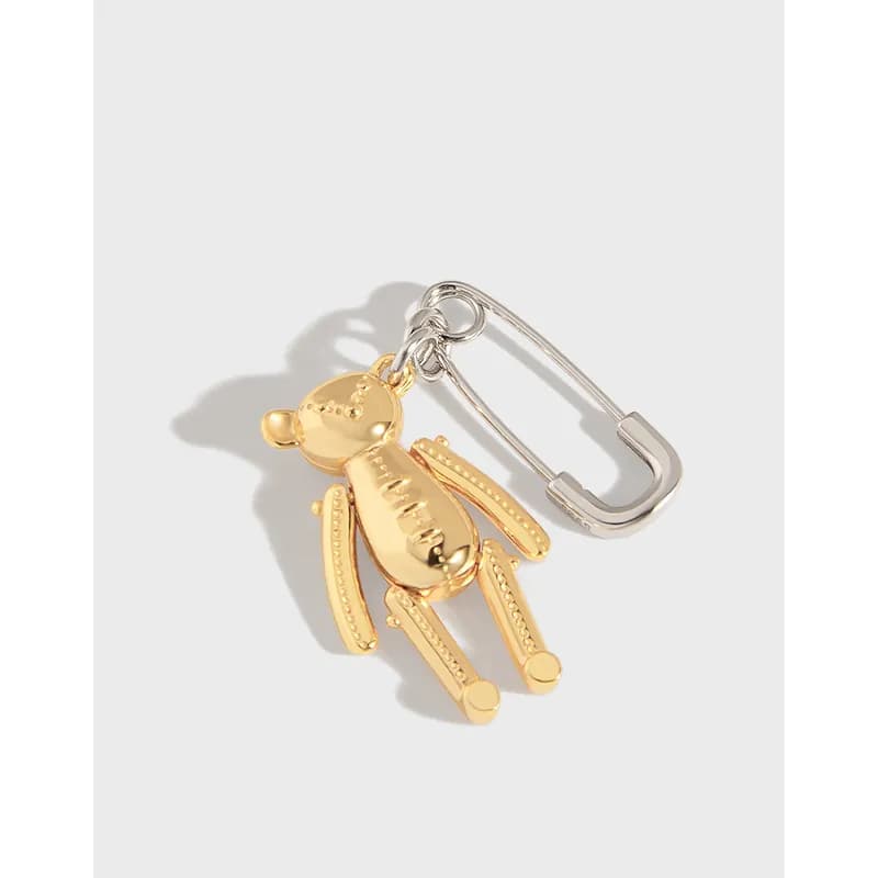Sterling silver earring with a dangling enamel bear charm on a safety-pin style hoop