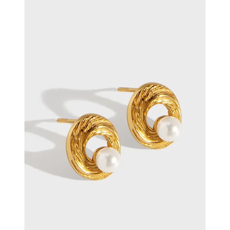 Gold-tone textured circle earrings with pearls and posts for pierced ears.