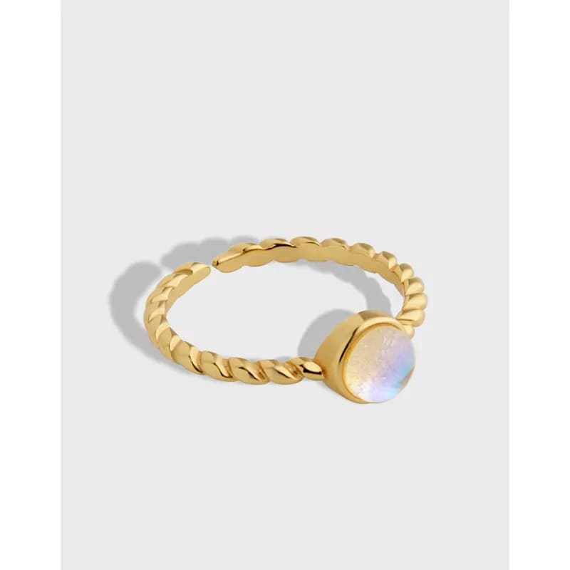 Polished sterling silver twisted rope ring with a round iridescent cabochon