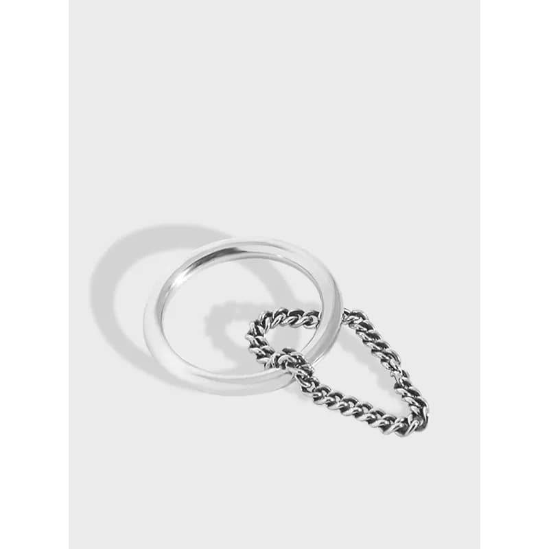 Sterling silver chain-link ring with matte finish and attached short chain detail.