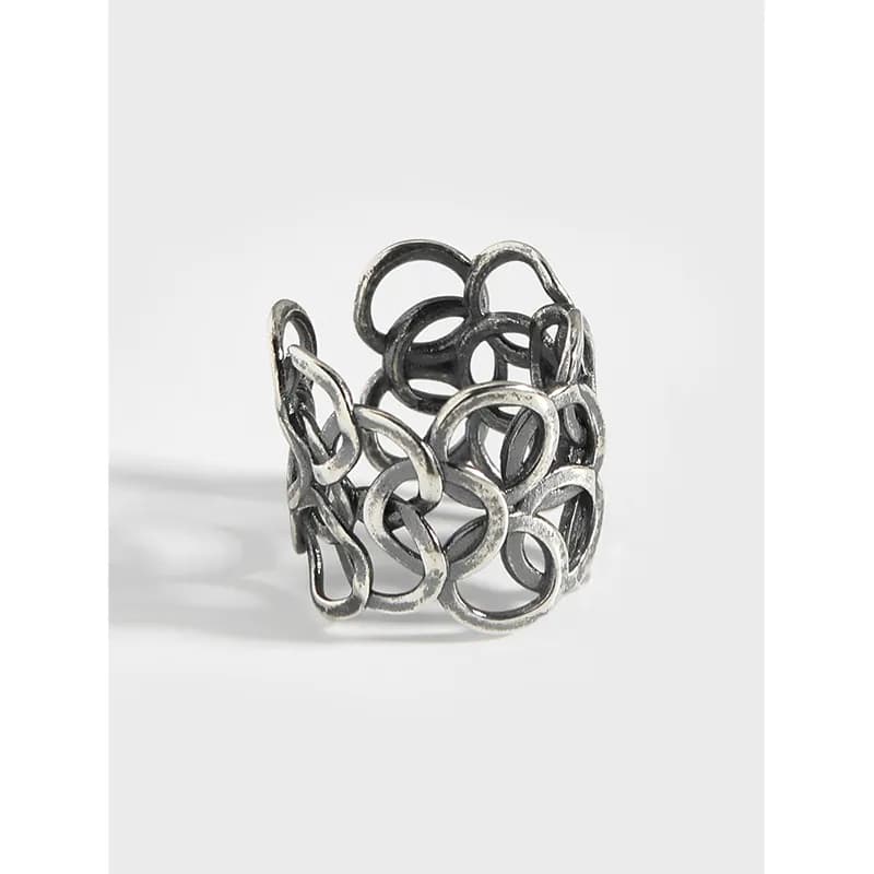 Sterling silver interlinked circle ring with an open lattice design and polished finish.
