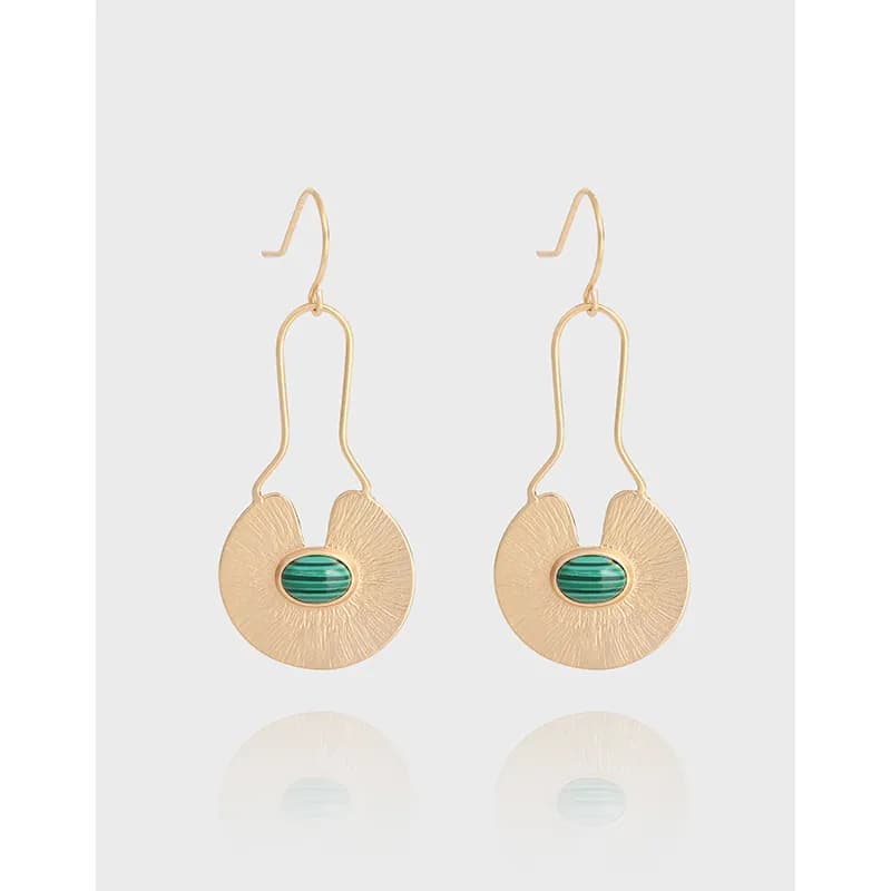 Polished sterling silver earrings with textured circular discs and green oval centers.