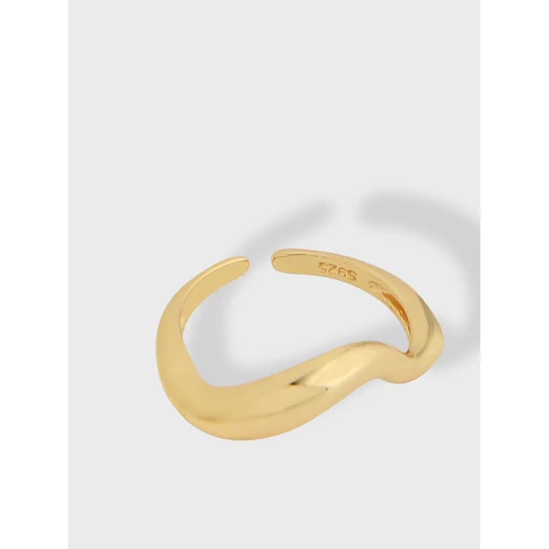 Polished sterling silver twisted open-band ring on a light neutral background.