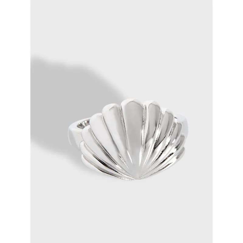 Polished scallop shell ring in sterling silver shown from a slightly angled view on a light background.