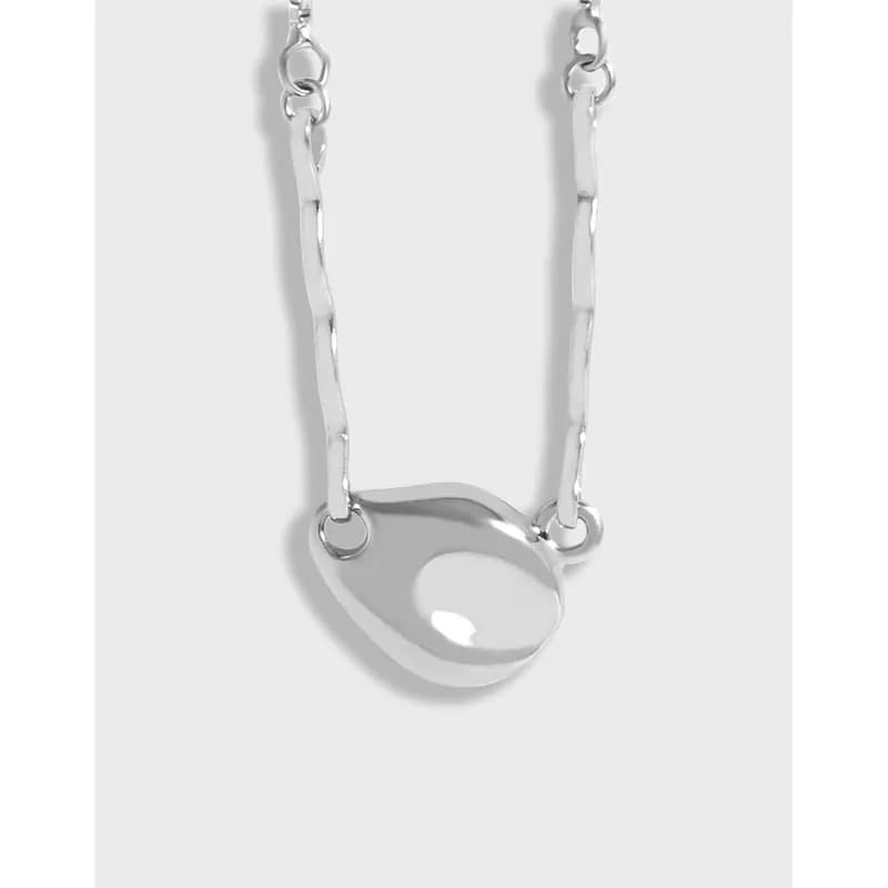Polished sterling silver Pebble Pendant Necklace with irregular circular pendant on a slim chain.