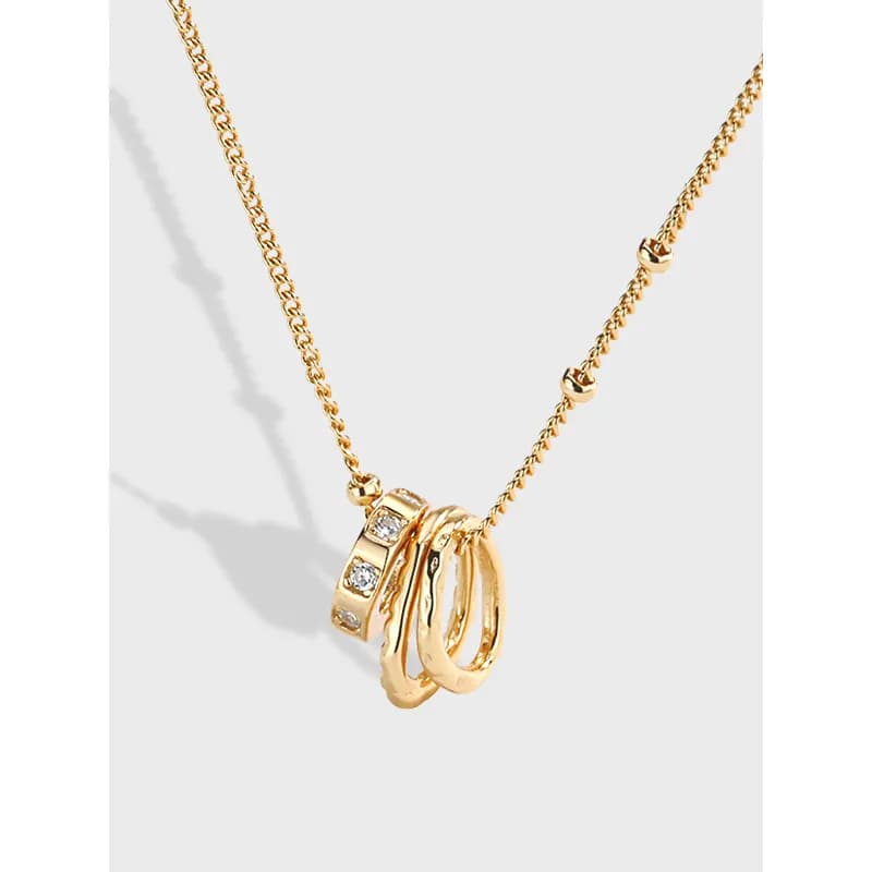 Sterling silver necklace with a cluster of interlocking rings pendant on a delicate chain.