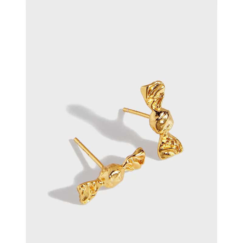 Polished bow-shaped stud earrings on a white background