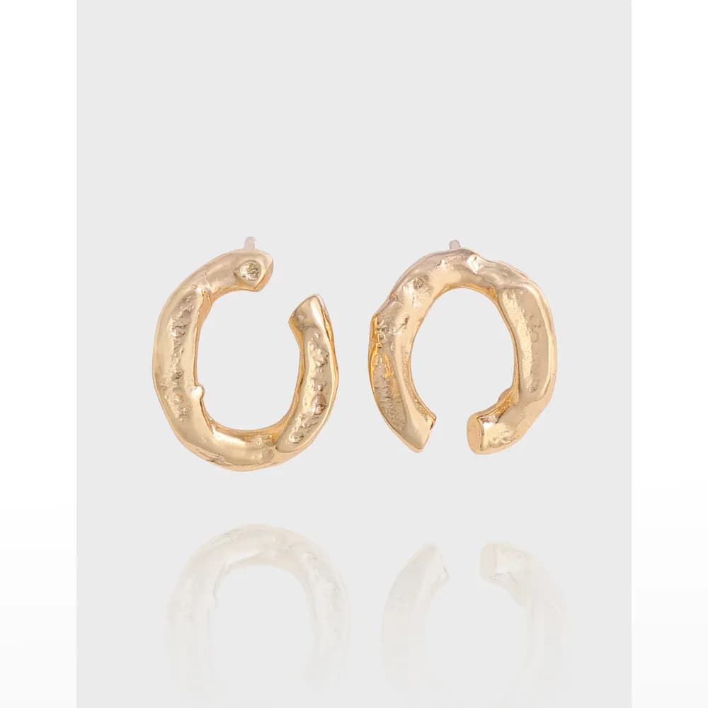 Two irregular hammered hoop earrings in a polished silver finish on a light background.