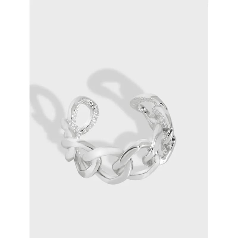 Polished sterling silver chain-link ring with textured pavé link on a white background.