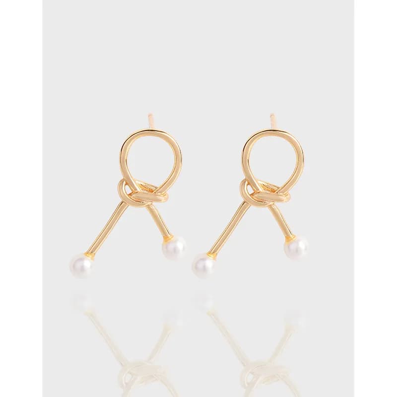 Polished sterling silver knot loop earrings with small pearl beads at the end of each dangling bar.