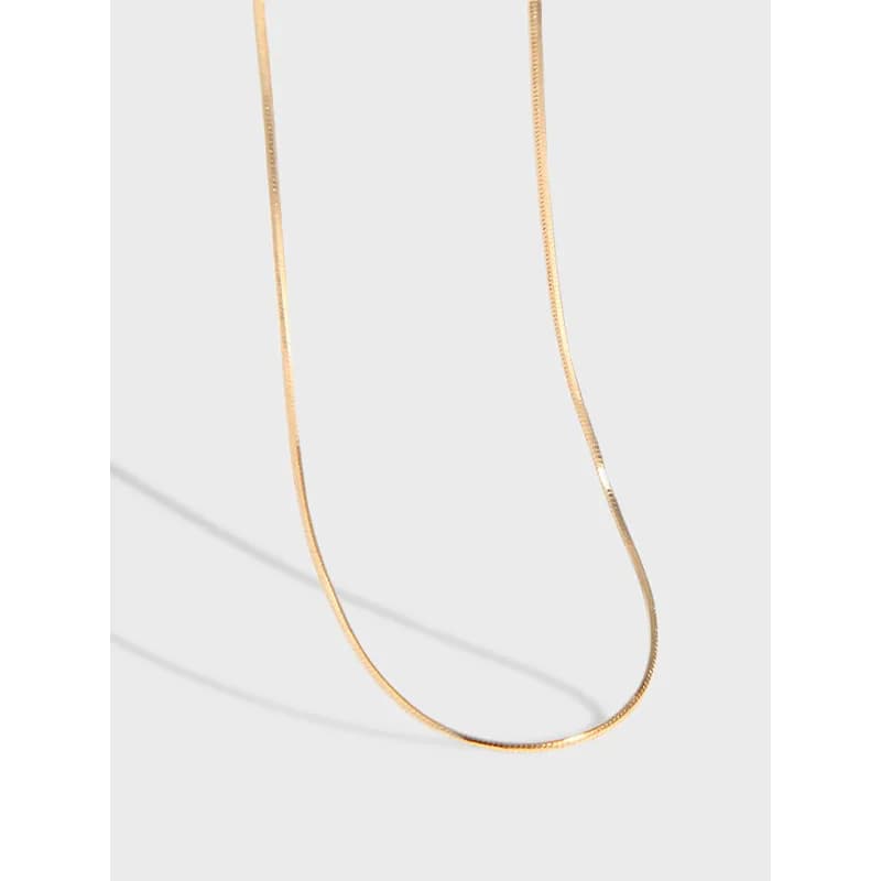 Polished curved snake chain necklace in sterling silver shown against a light background.