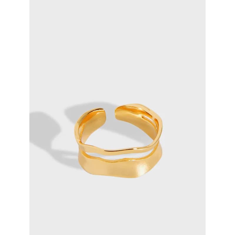 Polished sterling silver open ring with two interlocking, wavy bands on a light background.