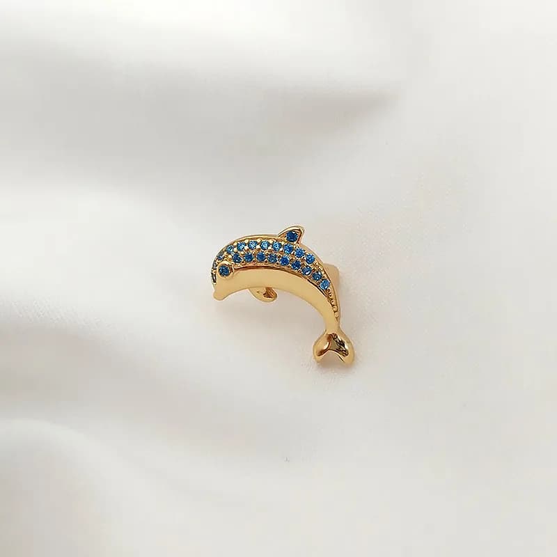 Polished sterling silver dolphin-shaped curved earring with blue stones along its back