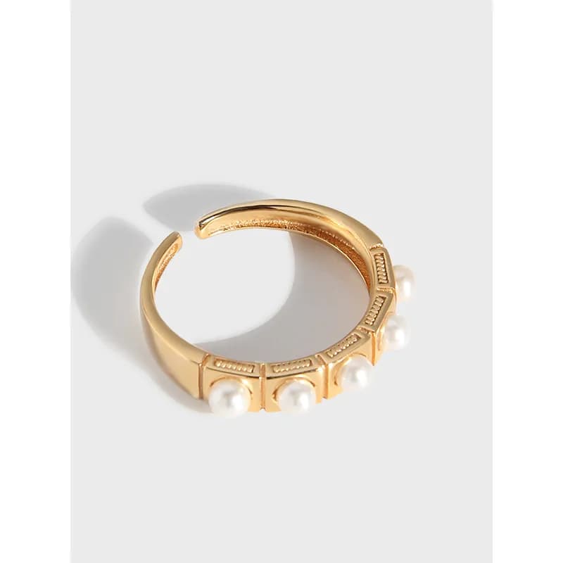 Open curved sterling silver ring with pearl beads along the outer edge.