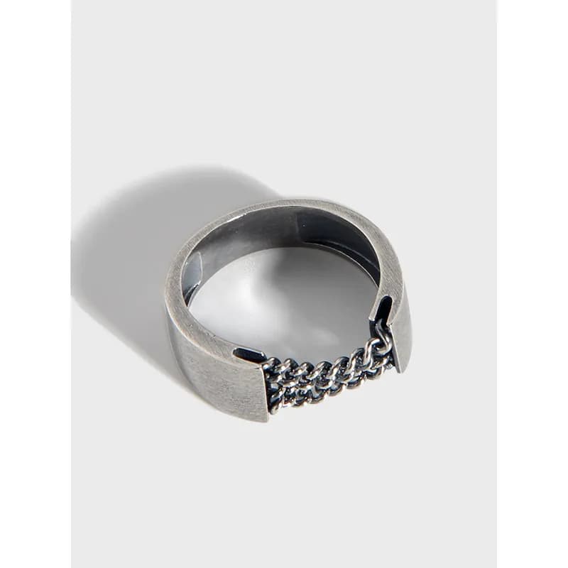 Polished sterling silver chain-link ring with open ends and a central linked detail.