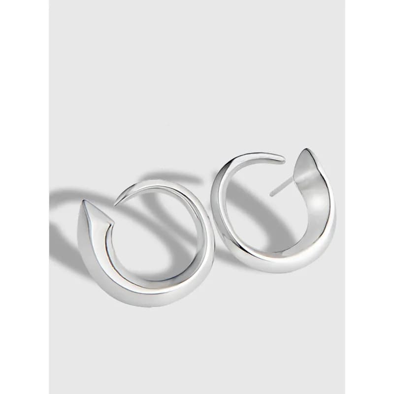 Polished sterling silver crescent hoop earrings on a light gray background.