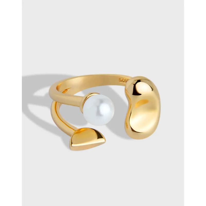Polished gold-tone sterling silver ring with an open sculptural design and a single white pearl bead.