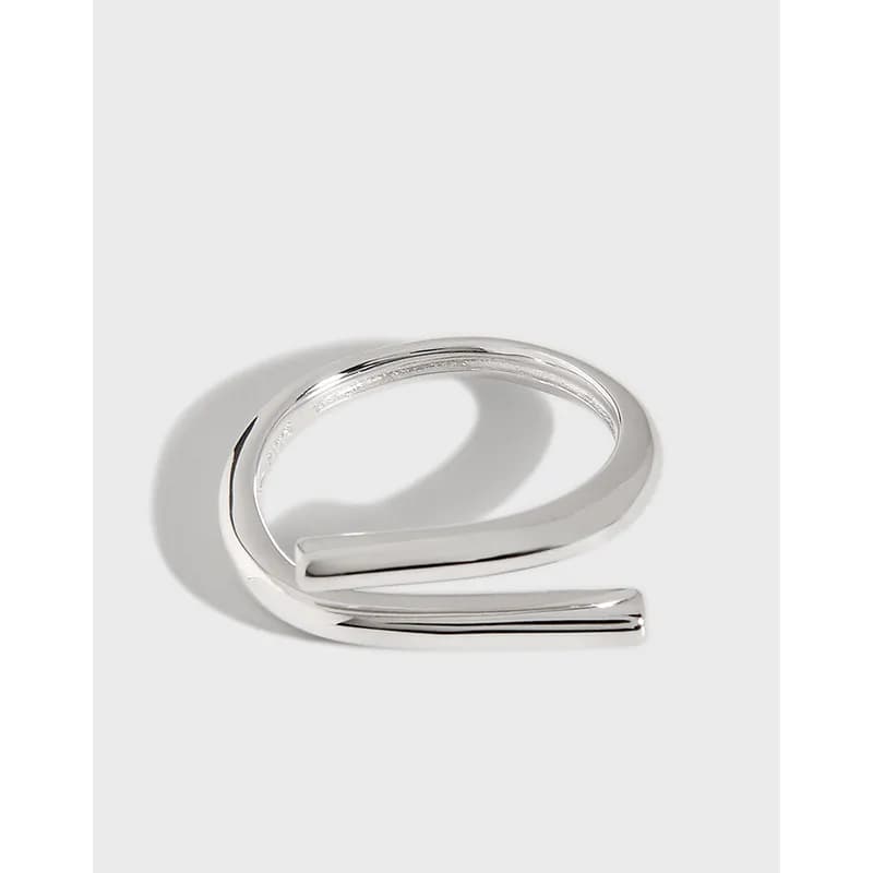 Polished sterling silver open C-shaped ring with two flat ends on a neutral background.