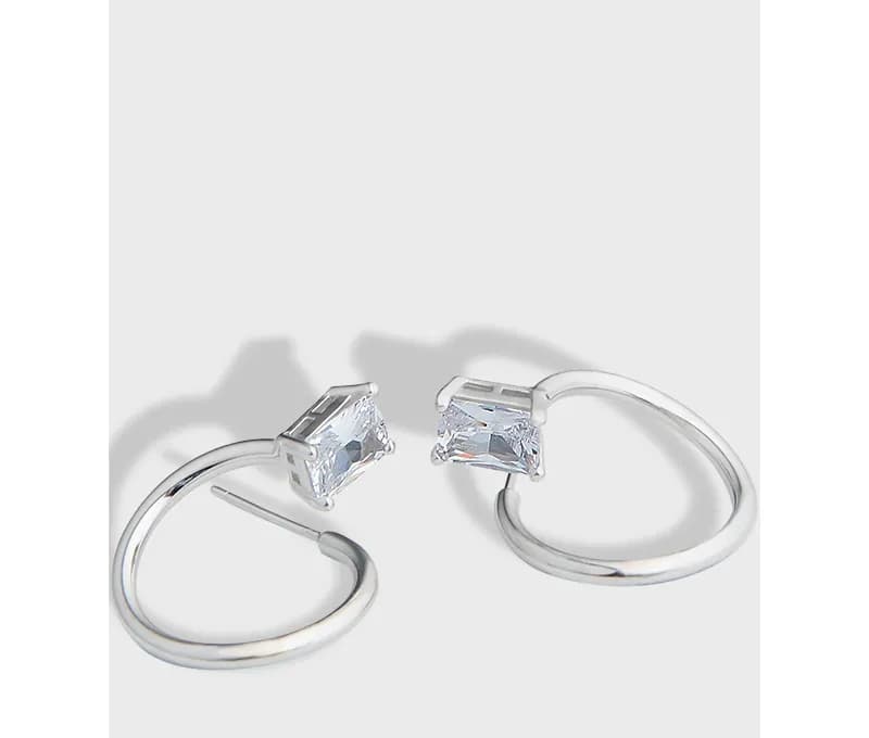 Polished sterling silver hoop earrings with rectangular crystals at the opening.