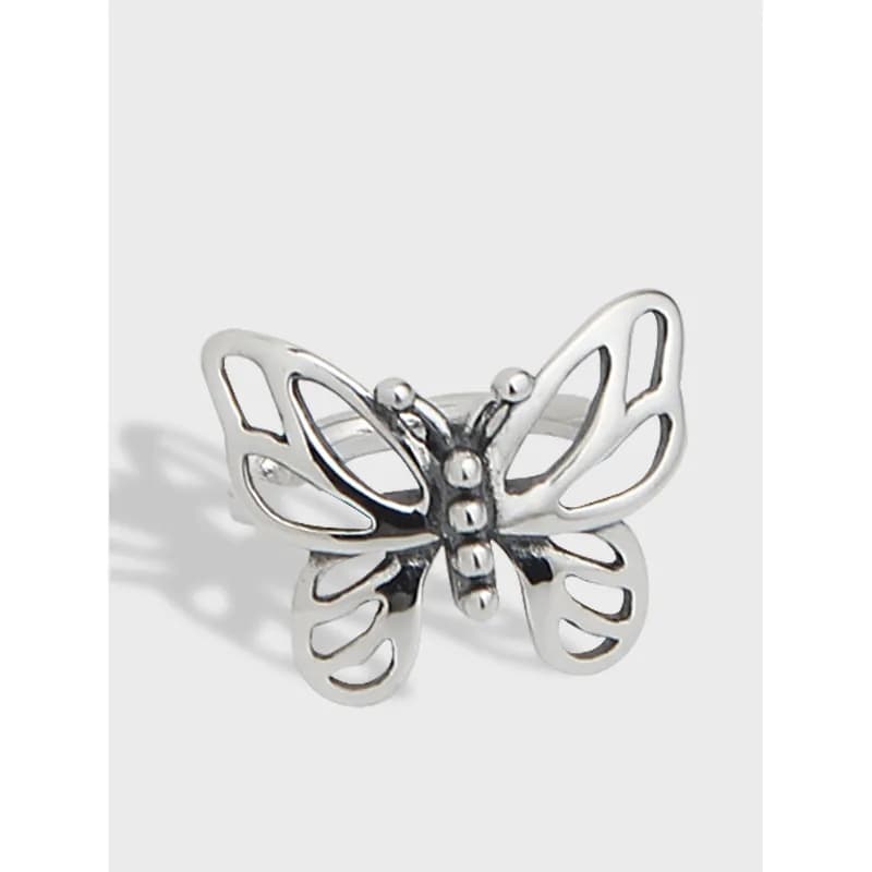Polished sterling silver butterfly cutout earrings displayed against a light background.