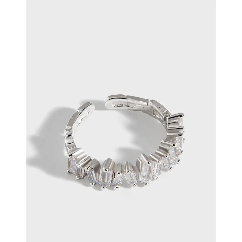 Polished sterling silver ring with a row of baguette-cut stones along the front arc.