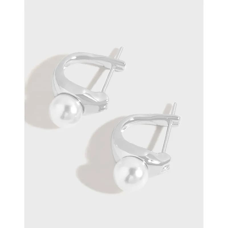 Polished sterling silver hoop earrings with a single white pearl accent at the front.