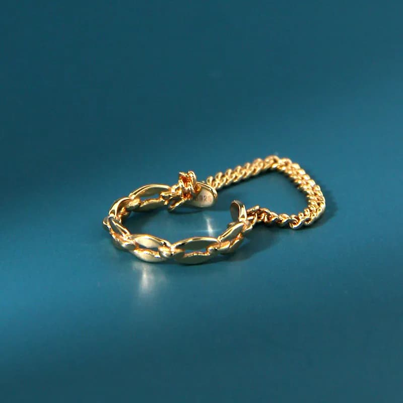 Polished sterling silver chain-link earrings resting on a blue surface.