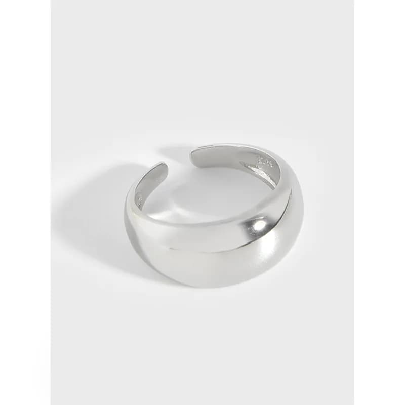 Polished sterling silver open curved ring with a wide band on a white background.
