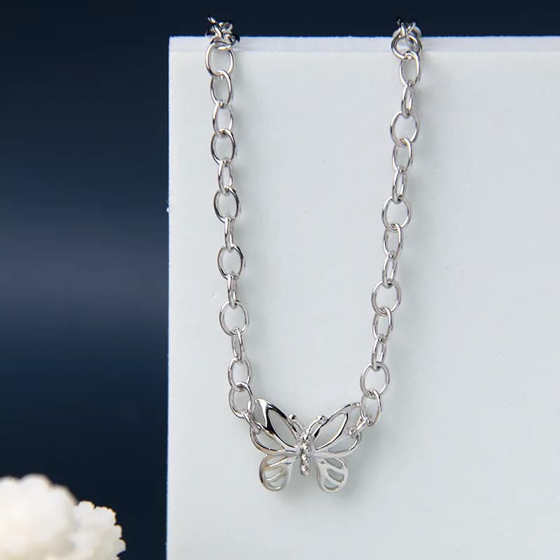 Polished sterling silver butterfly pendant on a chunky oval-link necklace
