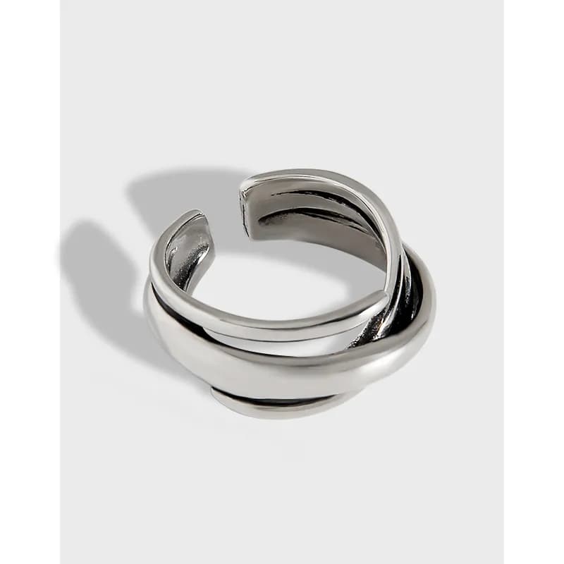 Polished spiral sterling silver ring with an open, overlapping wrap.