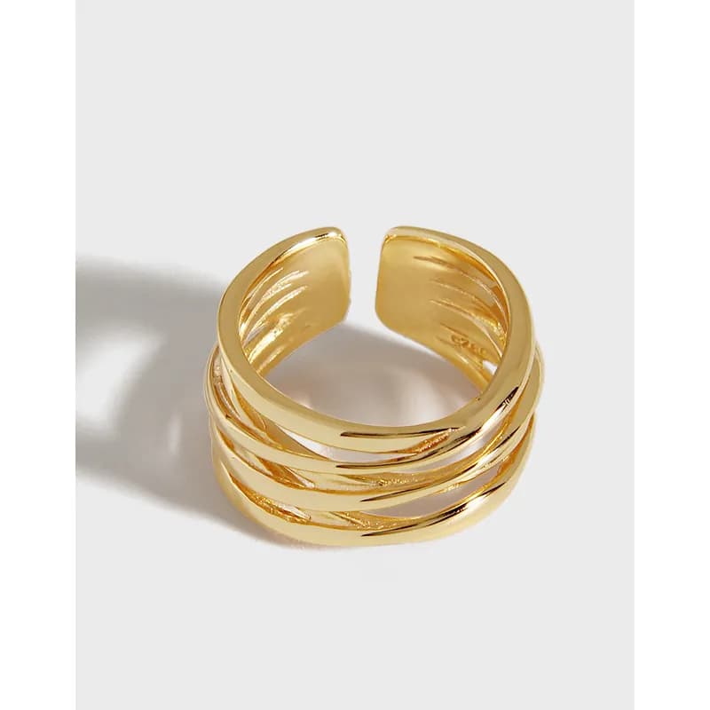 Polished sterling silver ring with four intertwined bands creating a stacked open-ring silhouette.