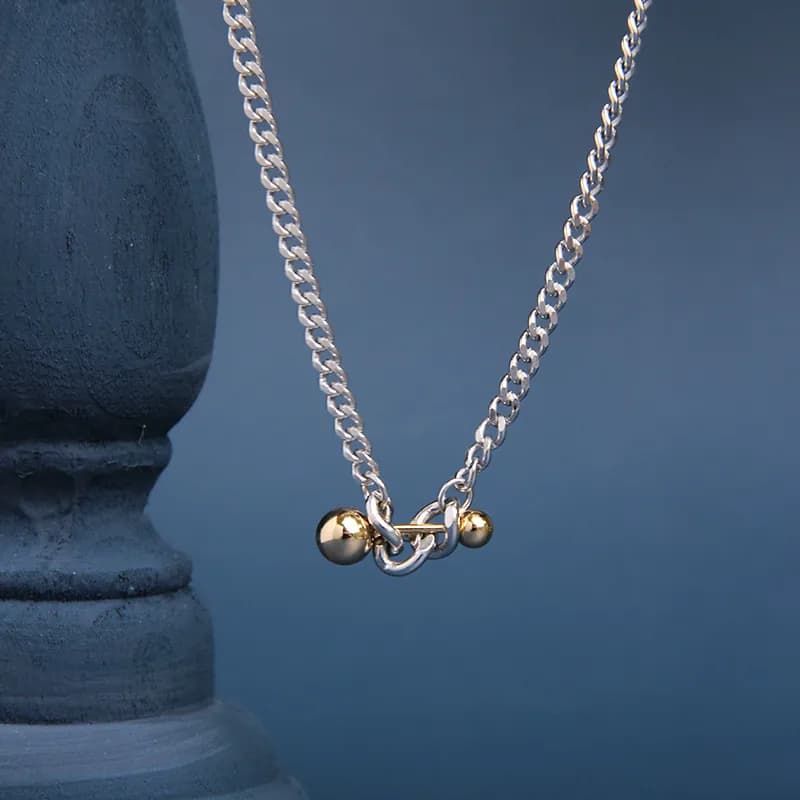 Polished sterling silver Ball Bar Necklace with gold-tone beads at the bar ends, worn centered on the chain.