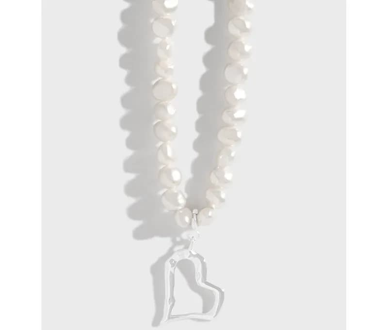 Two-strand freshwater pearl necklace with a polished silver open-heart pendant.