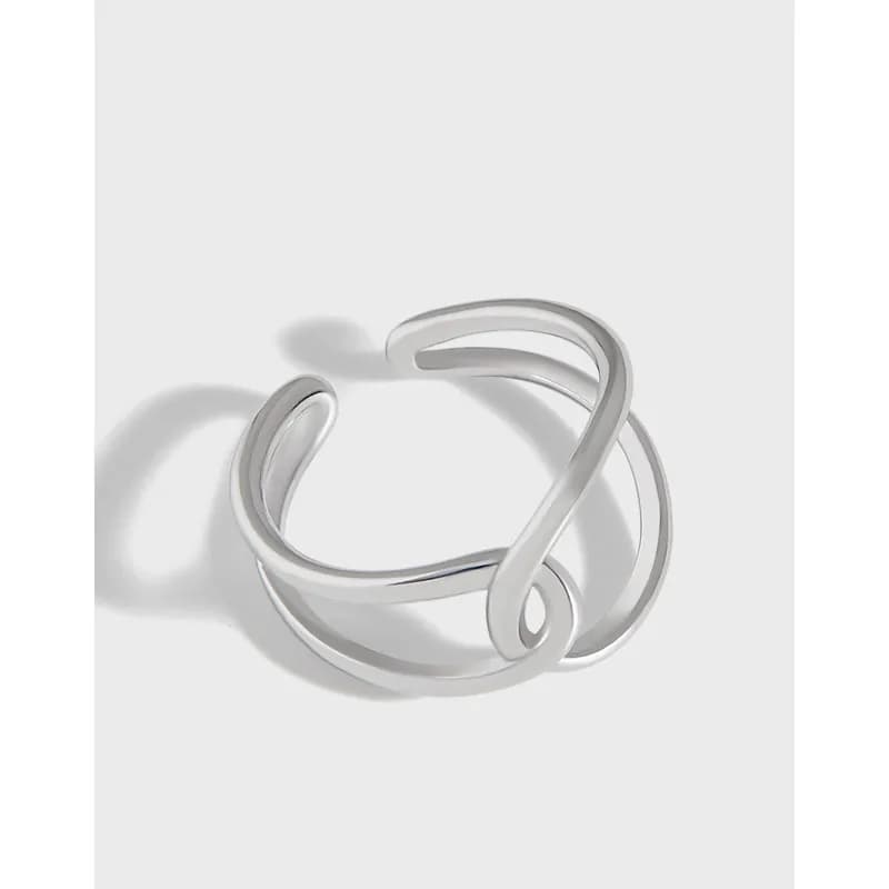 Polished Sterling Silver Open-Loop Ring with intertwined bands photographed in a bright studio setting.